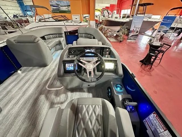 Slide: The Image of 2025 Bennington 24 LXSBA pontoon boat in showroom with Yamaha engine. - 20