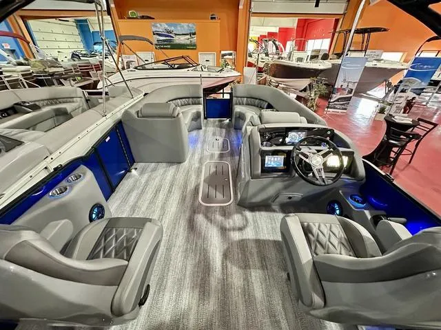 Slide: The Image of 2025 Bennington 24 LXSBA pontoon boat displayed in a showroom. - 21