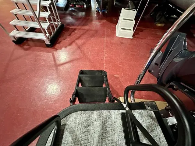 Slide: The Image of 2025 Bennington 24 LXSBA pontoon boat in showroom, featuring sleek design and modern amenities. - 24