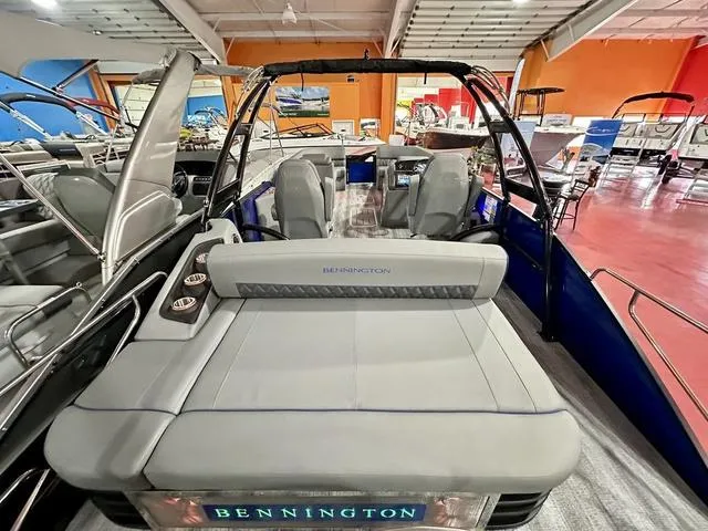 Slide: The Image of 2025 Bennington 24 LXSBA pontoon boat displayed in showroom. - 25