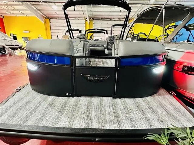 Slide: The Image of 2025 Bennington 24 LXSBA pontoon boat on display in a showroom. - 3