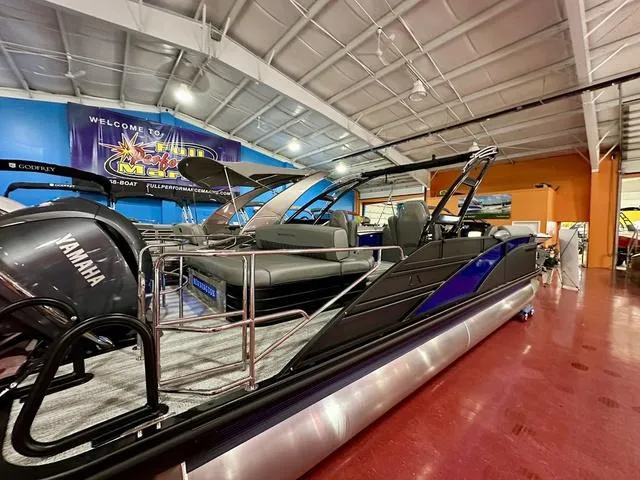 Slide: The Image of 2025 Bennington 24 LXSBA pontoon boat with Yamaha engine in showroom. - 32