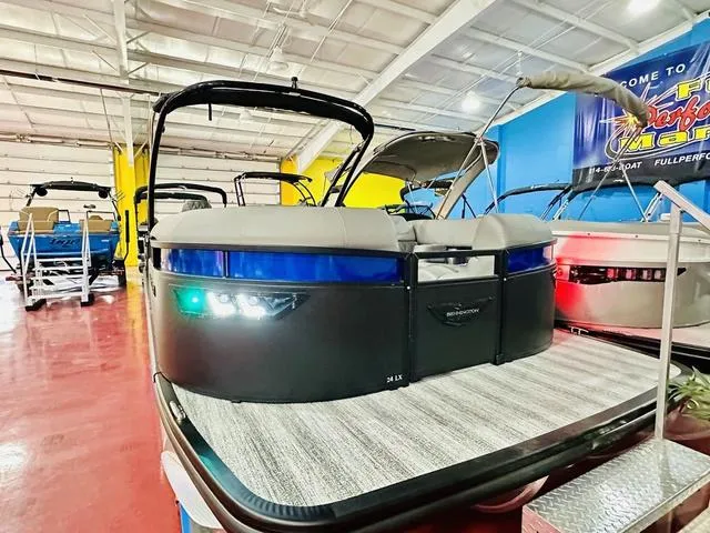 Slide: The Image of 2025 Bennington 24 LXSBA pontoon boat in showroom with luxurious seating. - 5