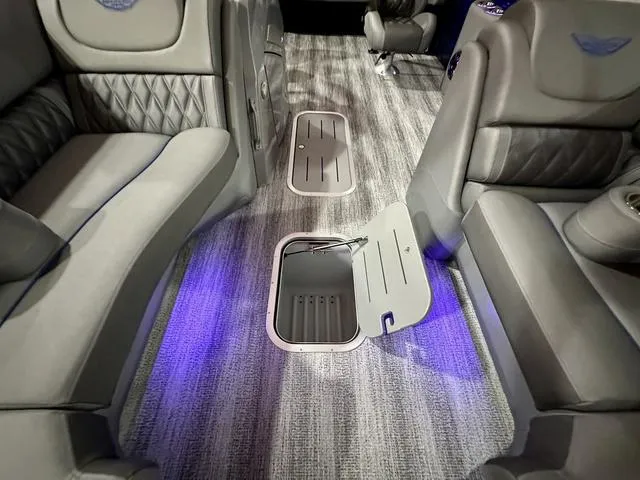 Slide: The Image of 2025 Bennington 24 LXSBA pontoon boat with Yamaha outboard motor in showroom. - 8