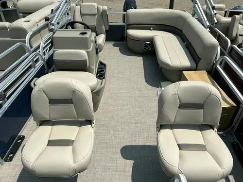 Slide: The Image of 2025 Sun Tracker Bass Buggy 16 XL Select pontoon boat interior with beige seating. - 5