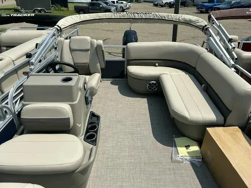 Slide: The Image of 2025 Sun Tracker Bass Buggy 16 XL Select pontoon boat interior with beige seating. - 8