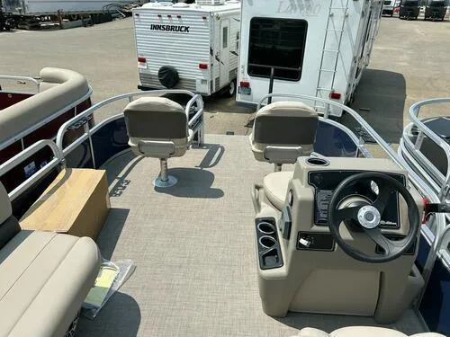 Slide: The Image of 2025 Sun Tracker Bass Buggy 16 XL Select pontoon boat interior with steering console and seating. - 9