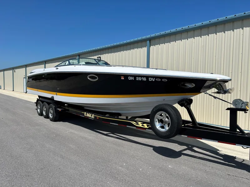 The Image of 2005 Cobalt 343 boat on a trailer in front of a storage facility. - 1