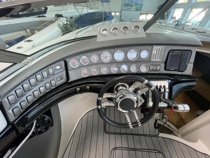 Slide: The Image of Dashboard of a 2005 Cobalt 343 boat with gauges and steering wheel. - 13