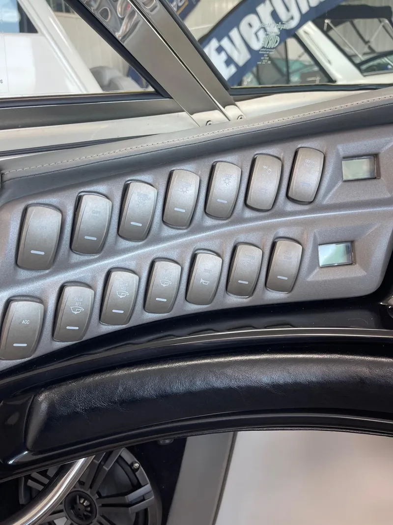 Slide: The Image of Control panel of a 2005 Cobalt 343 boat with multiple switches. - 14