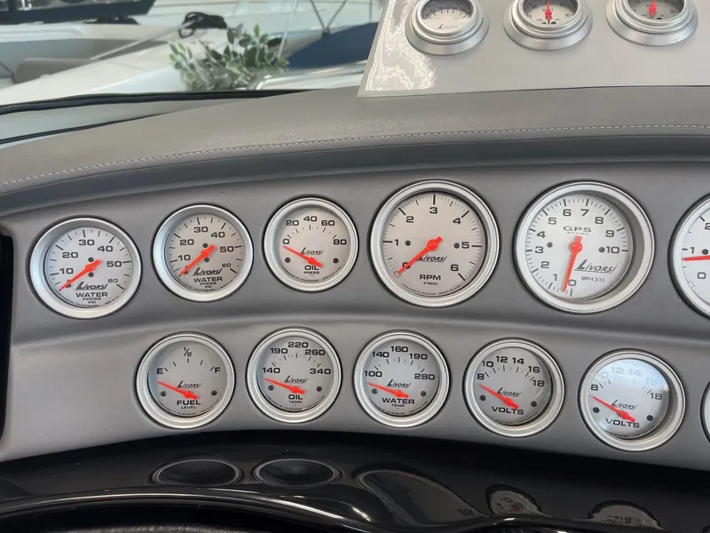 Slide: The Image of Dashboard of a 2005 Cobalt 343 boat with multiple gauges and dials. - 15