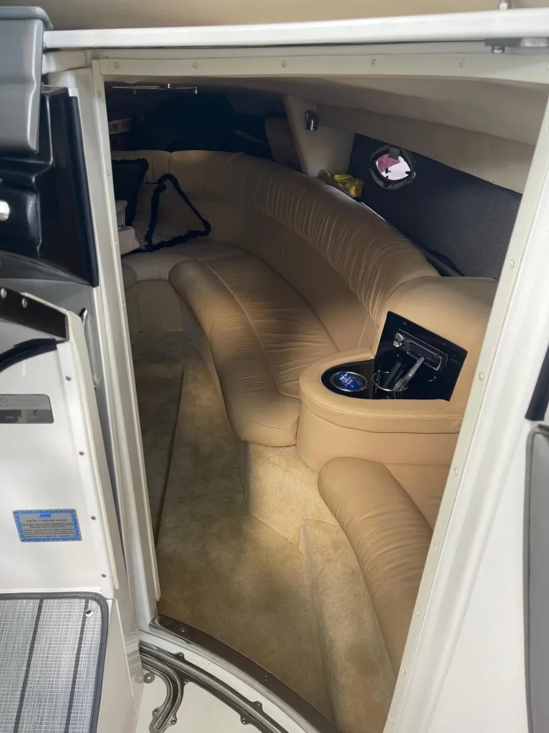 Slide: The Image of Interior of a 2005 Cobalt 343 boat with beige seating and modern amenities. - 20