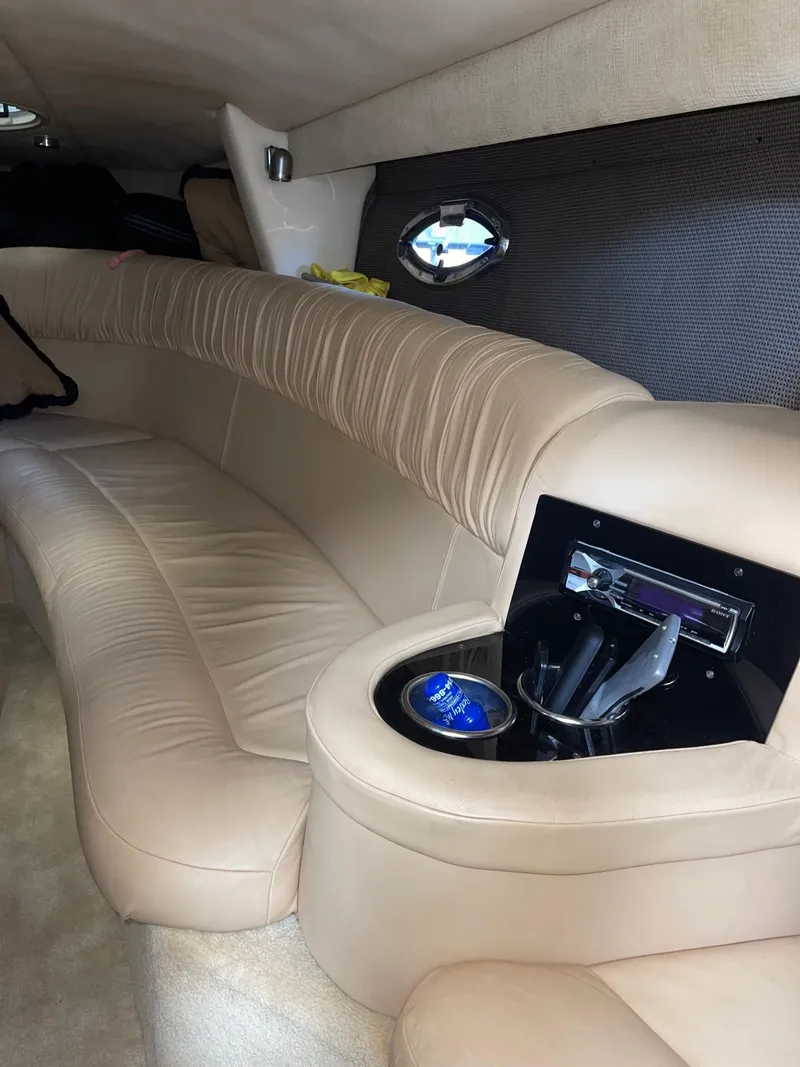 Slide: The Image of Luxurious interior of a 2005 Cobalt 343 boat with beige leather seating. - 21