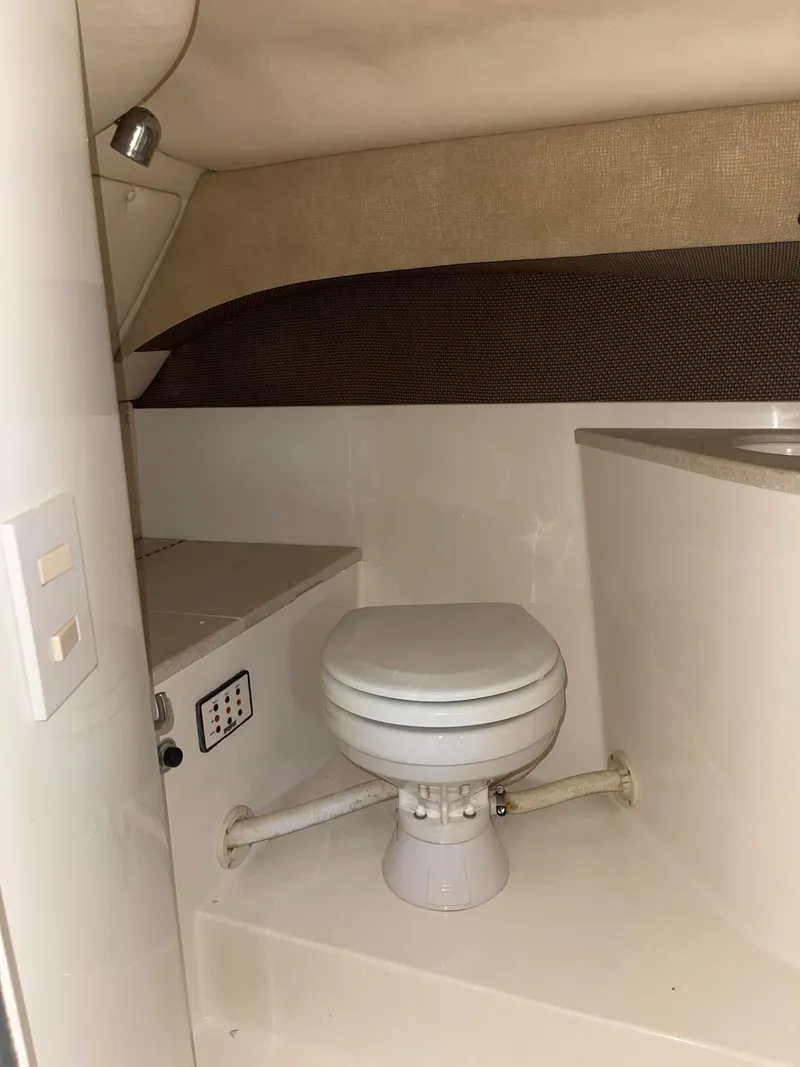 Slide: The Image of 2005 Cobalt 343 boat interior with compact marine toilet. - 22