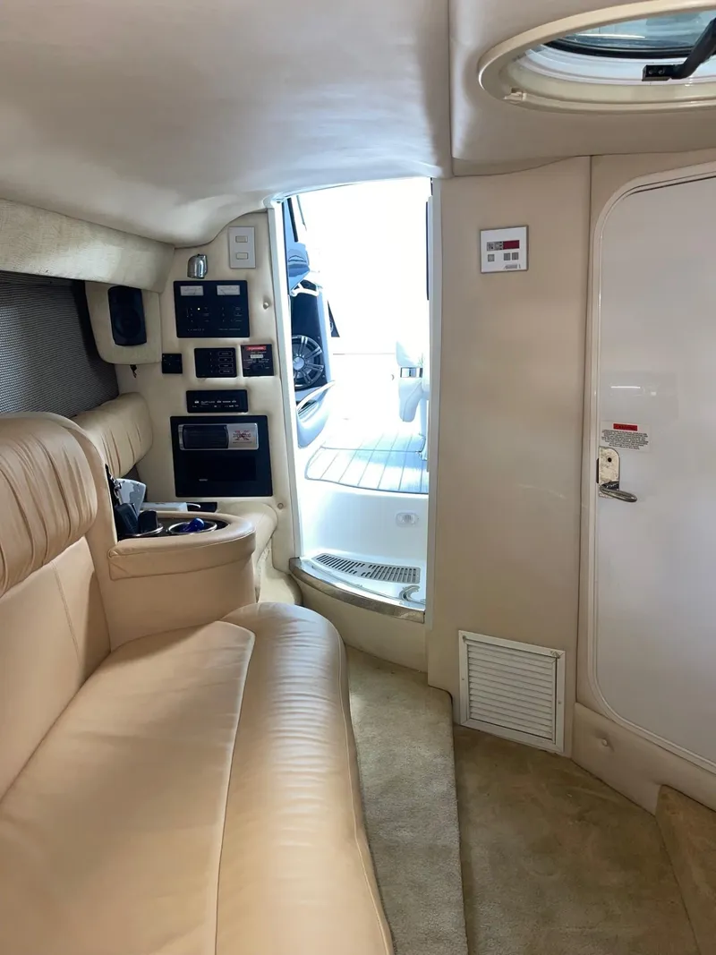 Slide: The Image of Luxurious interior of a 2005 Cobalt 343 boat with beige seating. - 23