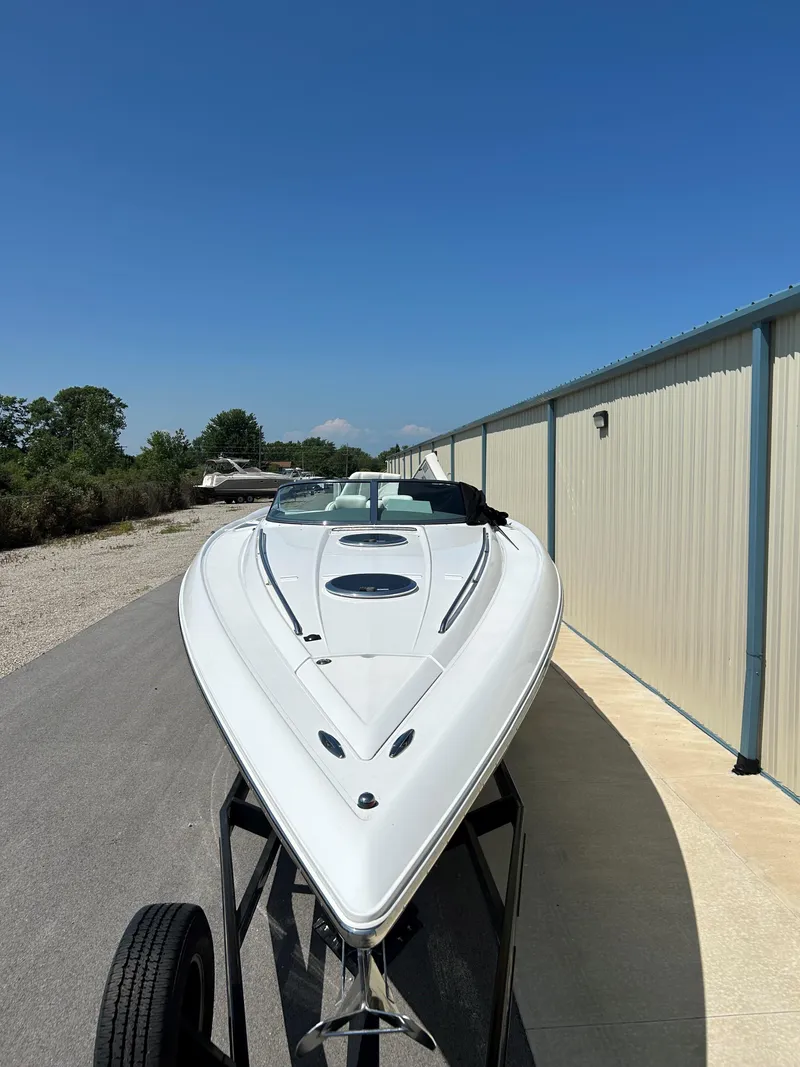 Slide: The Image of 2005 Cobalt 343 boat on trailer, parked near a building. - 3