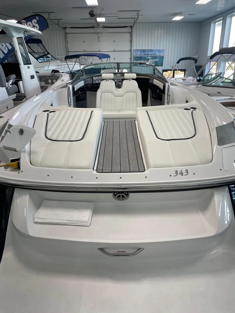 Slide: The Image of 2005 Cobalt 343 boat with white seating in a showroom. - 5
