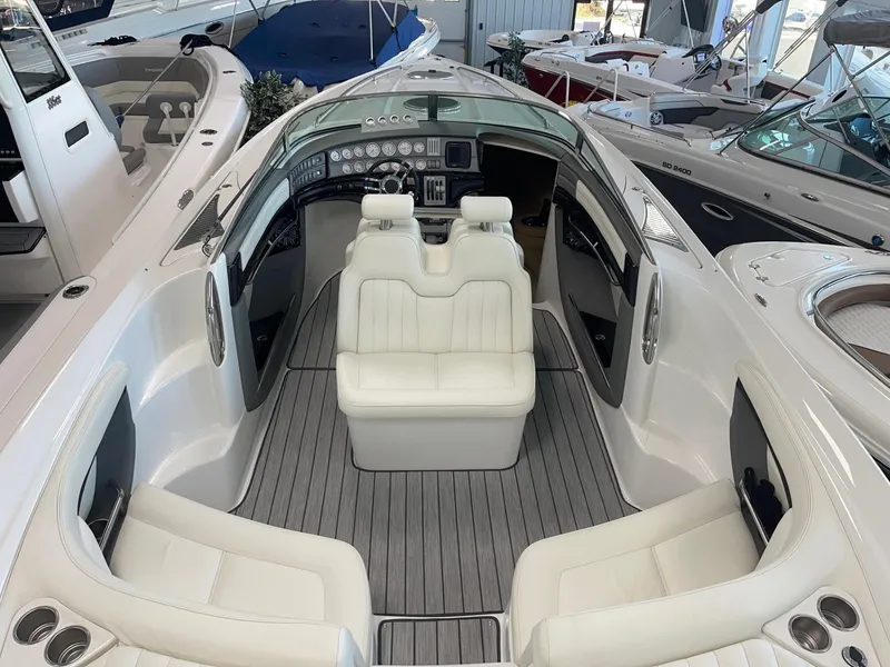 Slide: The Image of 2005 Cobalt 343 boat interior with white seating and modern dashboard. - 6