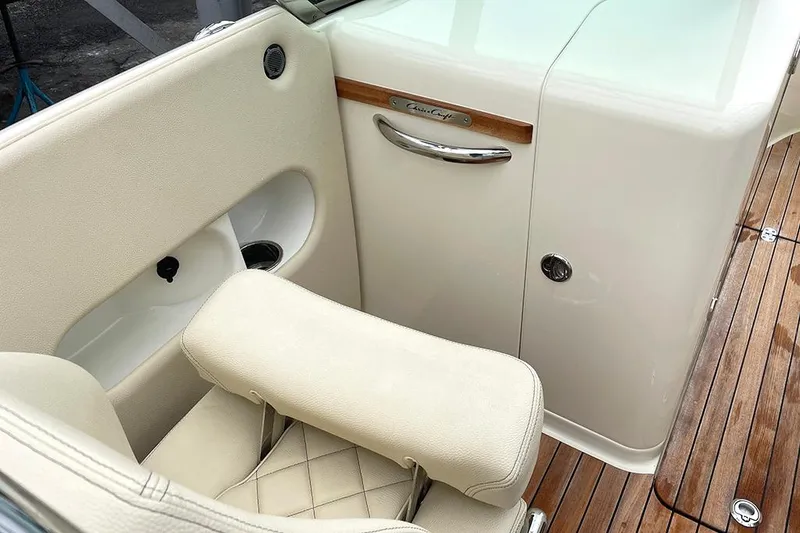 Slide: The Image of 2022 Chris-Craft Launch 27 interior with beige seating and wooden accents. - 13