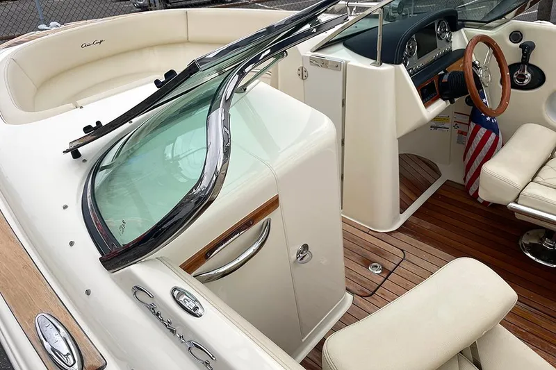 Slide: The Image of 2022 Chris-Craft Launch 27 boat interior with wooden accents and leather seating. - 2
