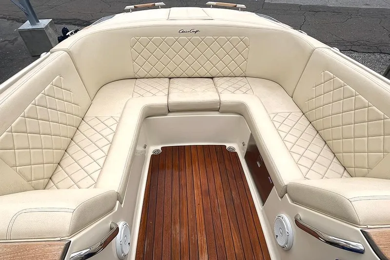 Slide: The Image of 2022 Chris-Craft Launch 27 boat with luxurious beige seating and wooden deck. - 5