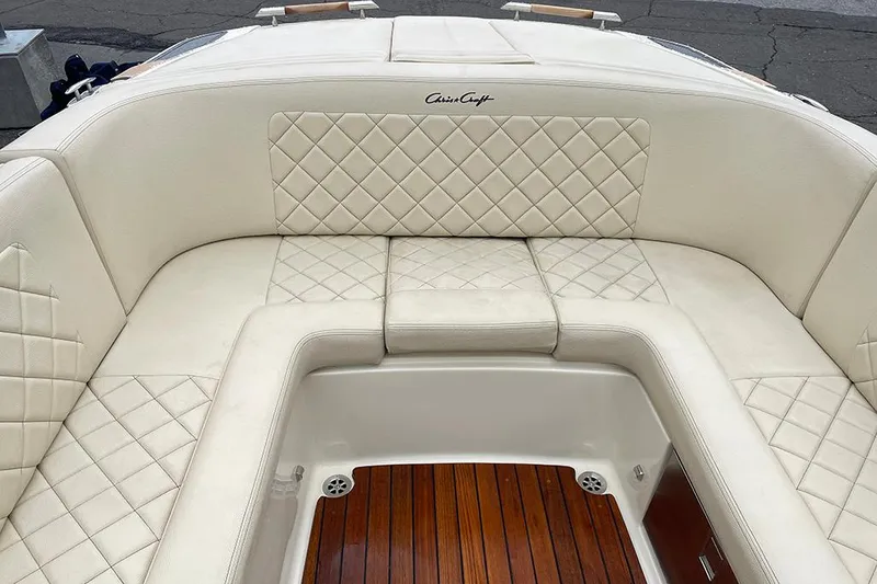 Slide: The Image of 2022 Chris-Craft Launch 27 boat with luxurious white leather seating and teak flooring. - 7