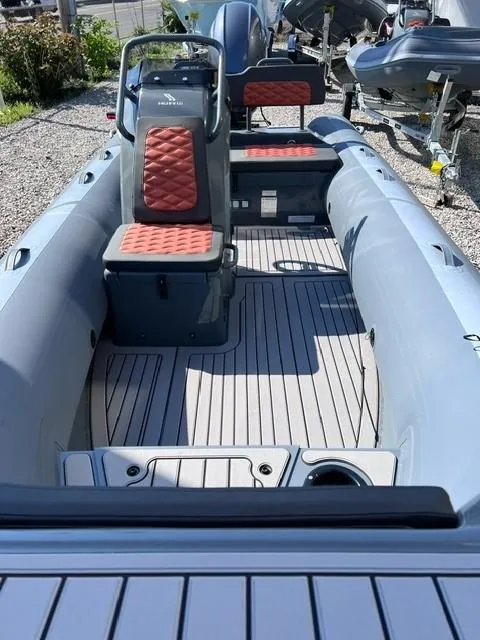 Slide: The Image of 2024 Highfield Sport 460 inflatable boat with red cushioned seats and gray deck. - 10