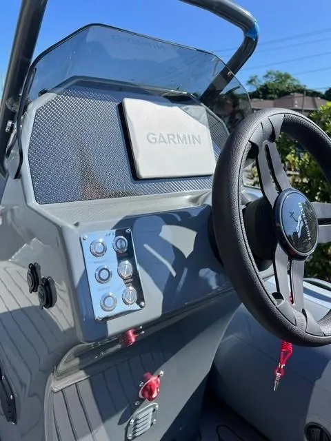 Slide: The Image of 2024 Highfield Sport 460 boat dashboard with Garmin navigation system. - 6