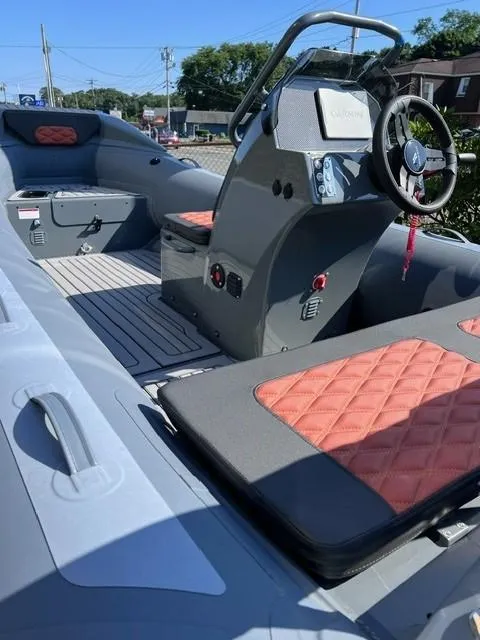 Slide: The Image of 2024 Highfield Sport 460 boat interior with steering console and seating. - 8