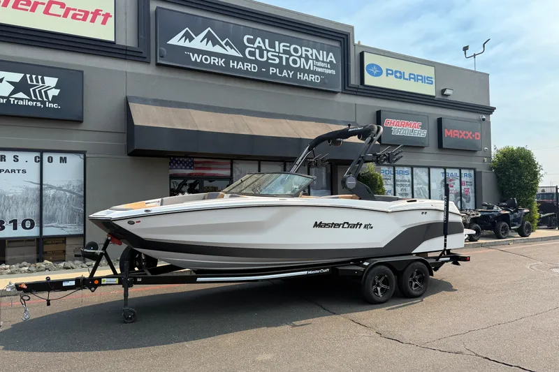The Image of 2024 MasterCraft NXT23 boat on trailer outside California Custom store. - 0