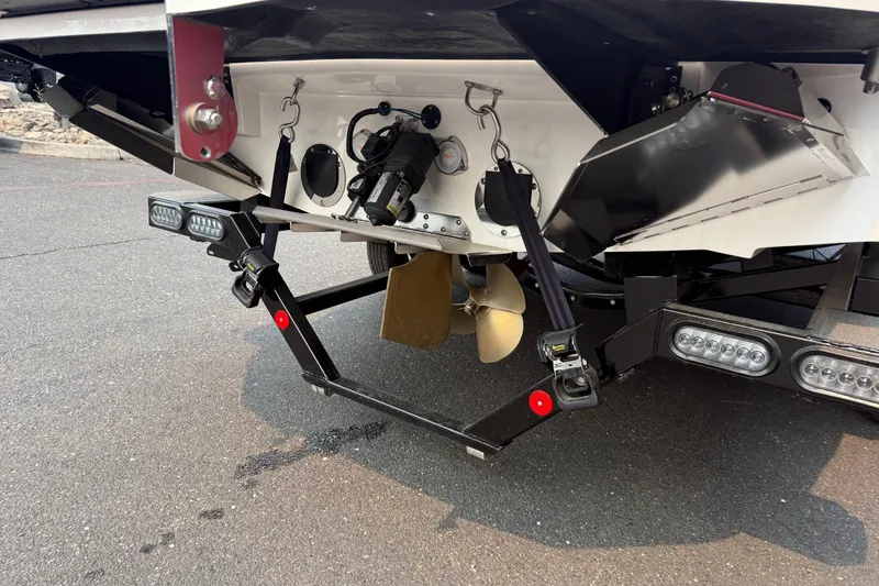 Slide: The Image of 2024 MasterCraft NXT23 boat stern with propeller and trailer details. - 12