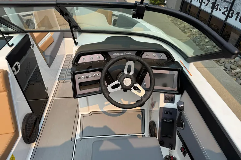 Slide: The Image of 2024 MasterCraft NXT23 boat cockpit with modern steering and control panel. - 14