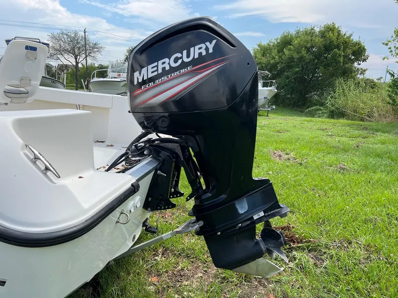 Slide: The Image of 2015 Mako 184 CC boat with Mercury outboard motor on grassy area. - 10