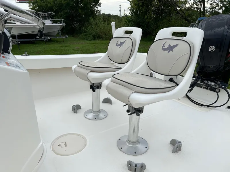 Slide: The Image of 2015 Mako 184 CC boat with two cushioned swivel seats on deck. - 4