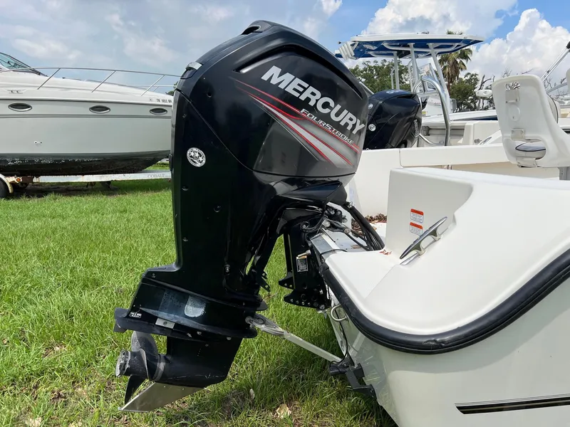 Slide: The Image of 2015 Mako 184 CC boat with Mercury outboard motor on grassy area. - 9
