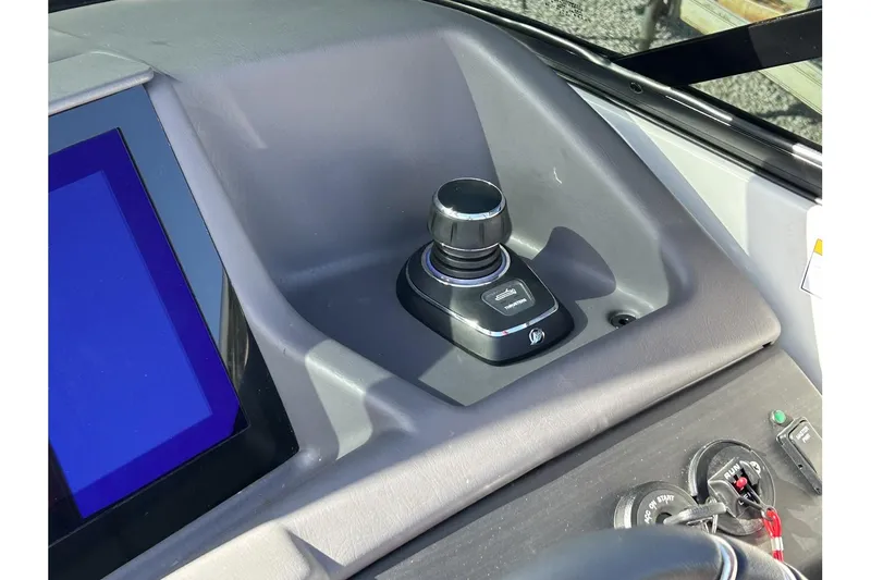 Slide: The Image of 2023 Bennington QX Sport 25 boat control panel with joystick and touchscreen. - 10