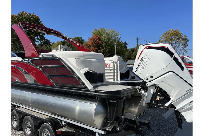 Slide: The Image of 2023 Bennington QX Sport 25 pontoon boat with a powerful outboard motor. - 3