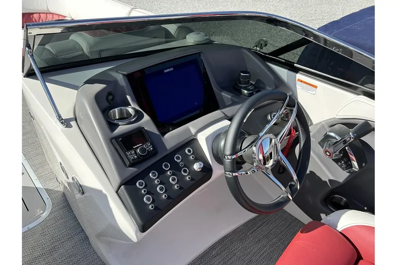 Slide: The Image of 2023 Bennington QX Sport 25 boat dashboard with steering wheel and control panel. - 5