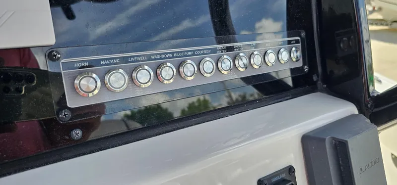 Slide: The Image of Control panel of 2023 Tidewater 232 LXF boat with labeled buttons. - 11