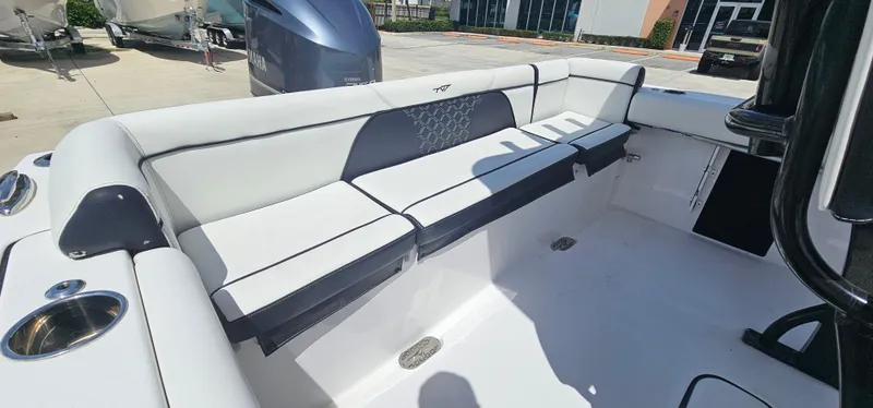 Slide: The Image of 2023 Tidewater 232 LXF boat interior with white cushioned seating. - 12