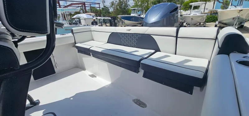 Slide: The Image of 2023 Tidewater 232 LXF boat interior with cushioned seating and sleek design. - 14