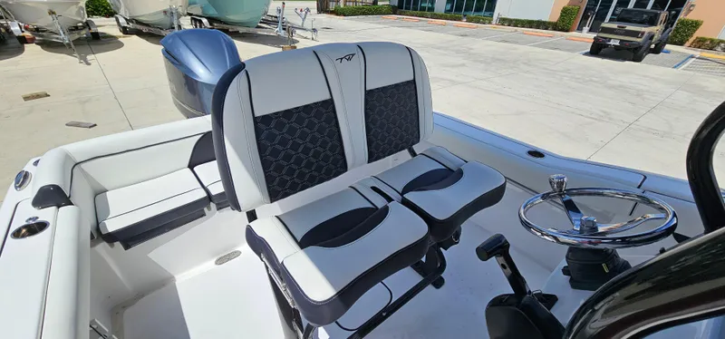 Slide: The Image of 2023 Tidewater 232 LXF boat interior with dual seats and steering wheel. - 17