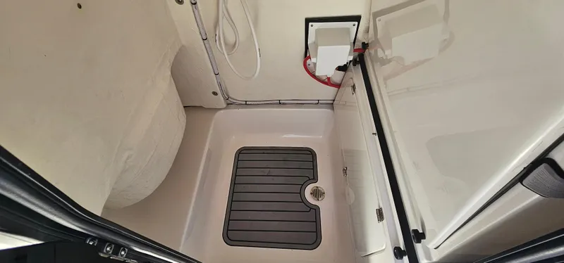 Slide: The Image of 2023 Tidewater 232 LXF boat interior compartment with drainage system. - 22