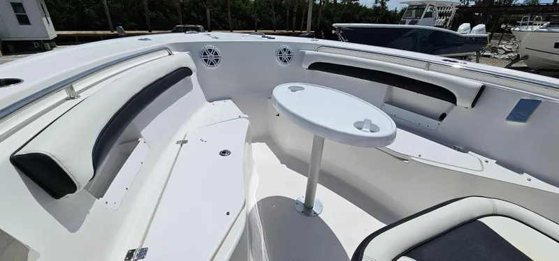 Slide: The Image of 2023 Tidewater 232 LXF boat interior with seating and table. - 25