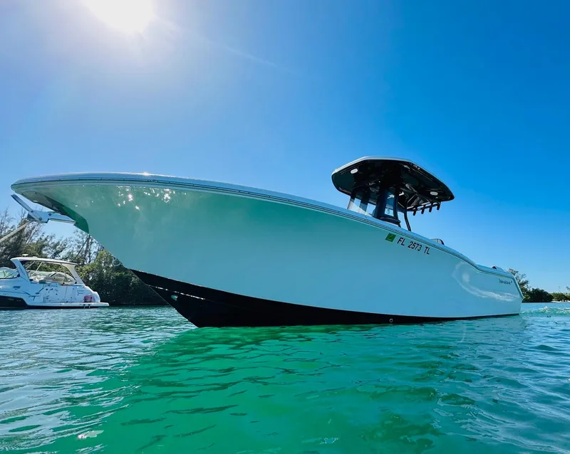Slide: The Image of 2023 Tidewater LXF boat on clear water under a bright blue sky. - 3