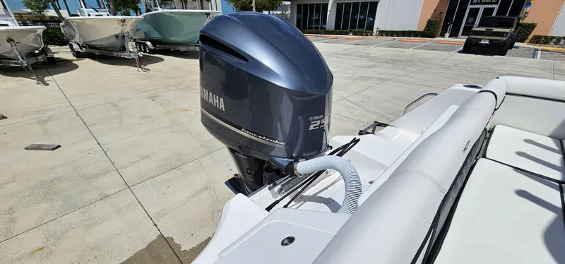 Slide: The Image of 2023 Tidewater 232 LXF boat with Yamaha outboard motor in a marina setting. - 30