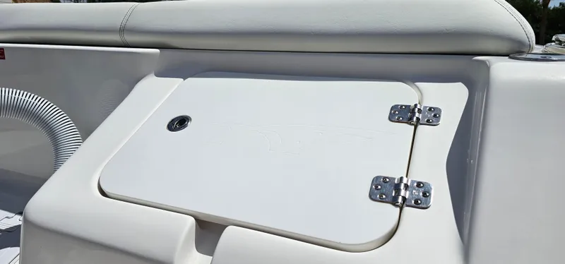 Slide: The Image of 2023 Tidewater 232 LXF boat storage compartment with cushioned seating. - 31