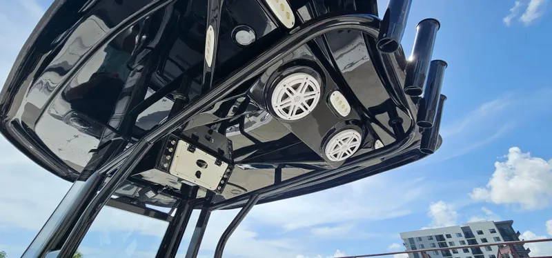 Slide: The Image of 2023 Tidewater 232 LXF boat T-top with speakers against blue sky. - 5