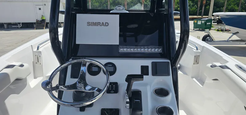 Slide: The Image of 2023 Tidewater 232 LXF boat console with Simrad display and steering wheel. - 6