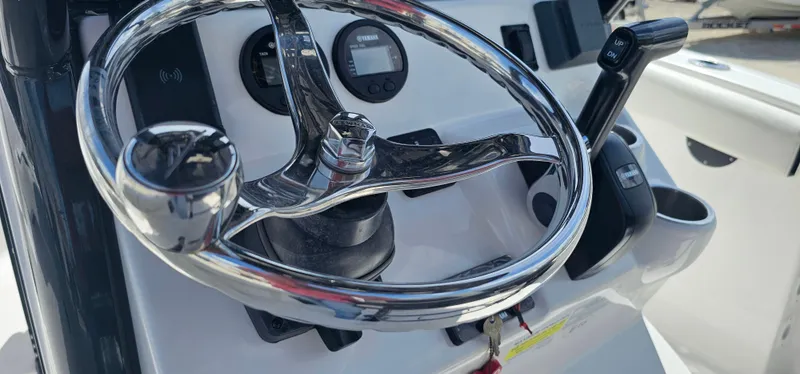 Slide: The Image of 2023 Tidewater 232 LXF boat steering wheel and controls. - 7
